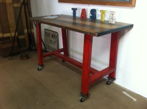 Red Metal Island Bench with Blackbutt Top on Castors